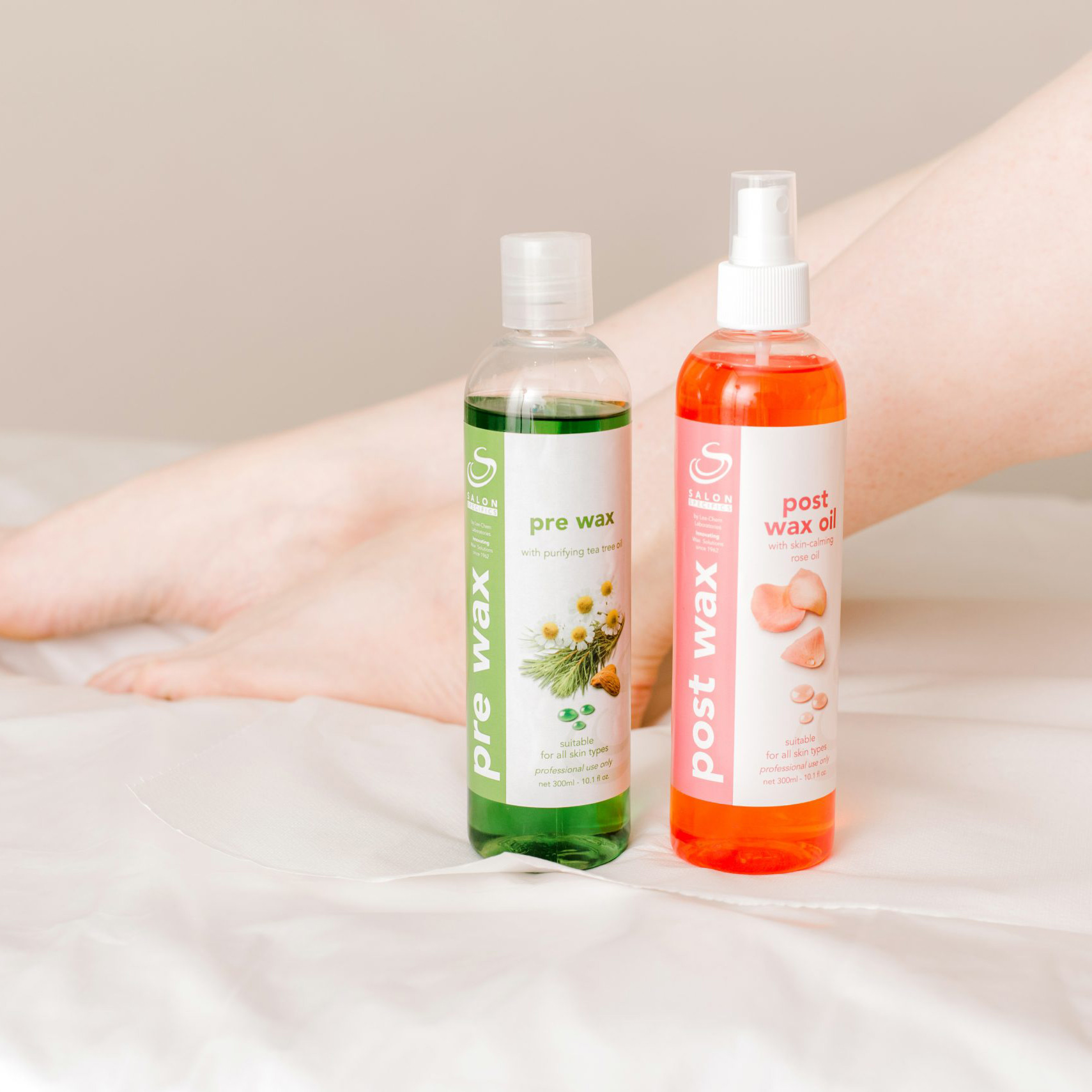 Two waxing product bottles (pre-wax and post-wax oil) stand on a white surface, with a pale background behind them.